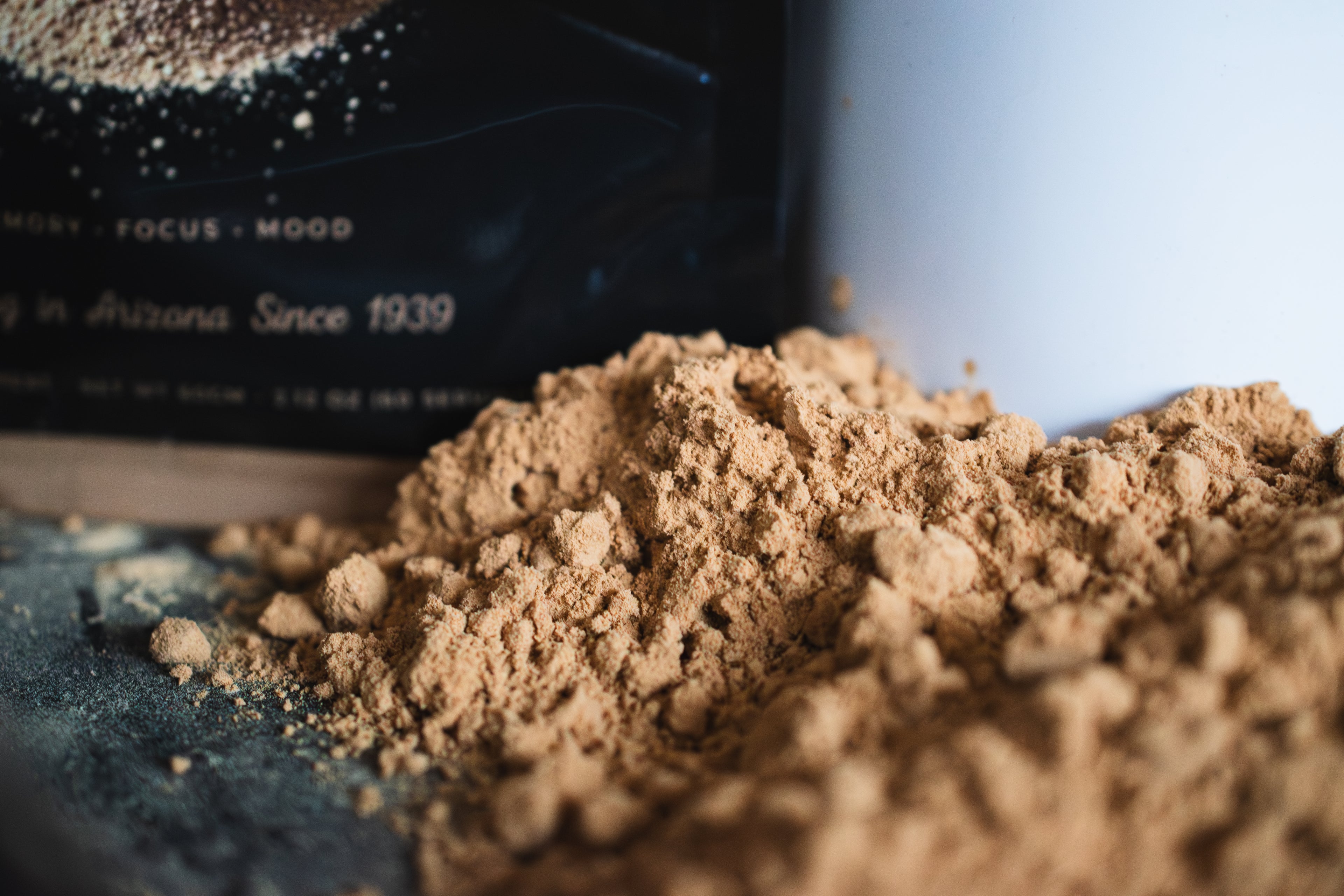 Dual Extract mushroom powder pile in front of Bkw mushroom co package